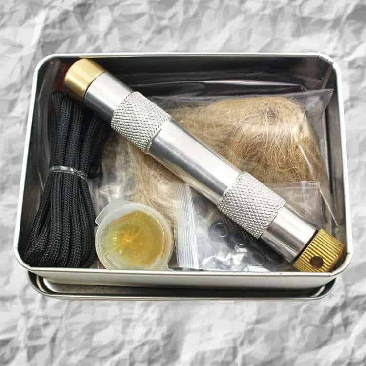FRC16 survival fire piston kit in a metal tin box with char cloth and jute, part of the ferro rod bulk FRC16 outdoor gear collection.