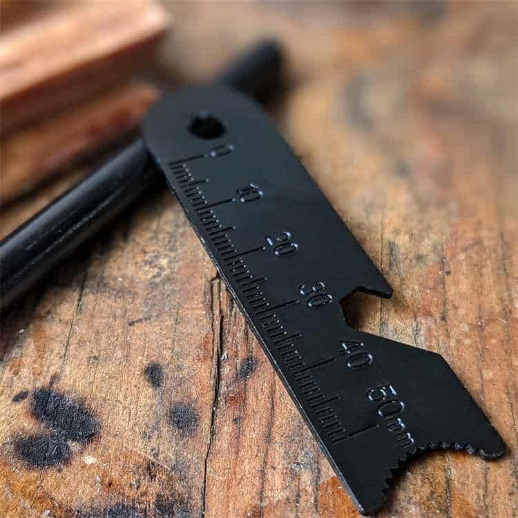 Close-up of bulk ferrocerium rods with pre-drilled lanyard holes and black anti-oxidation coating, part of the FRC17 professional survival gear series.