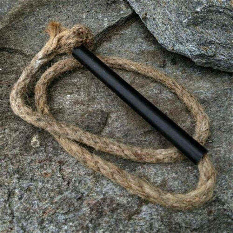 Close-up of natural fatwood tinder sticks and wax-infused hemp wick, ideal for use with high-quality bulk fire steel tools.