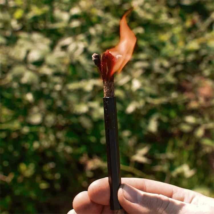 Demonstration of lighting a campfire using a bulk fire steel to produce intense sparks for emergency survival.
