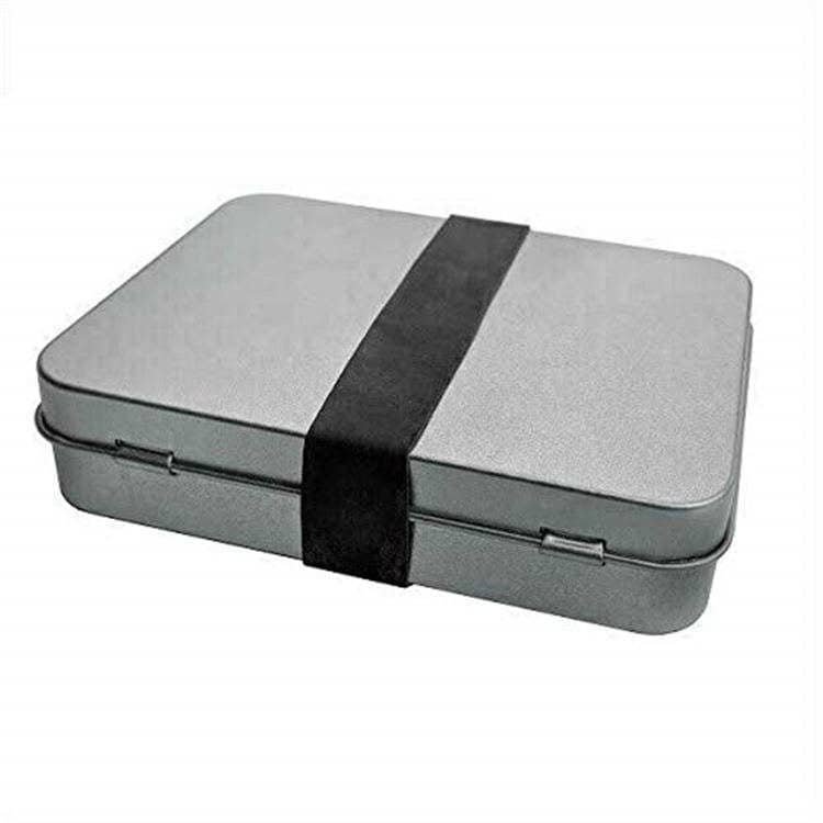 Compact EDC survival tin box containing FRC13 tinder torch and bulk fire steel components for outdoor backpacking.