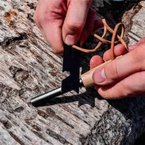 Hands striking a wooden-handle ferro rod with a black multi-tool scraper on a log