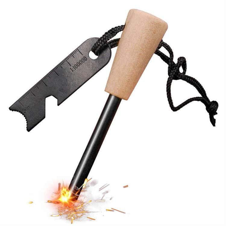 FRC31 premium ferro rod bulk fire starter with an ergonomic natural wooden handle throwing intense 3000 degree sparks next to a multi-tool steel scraper.
