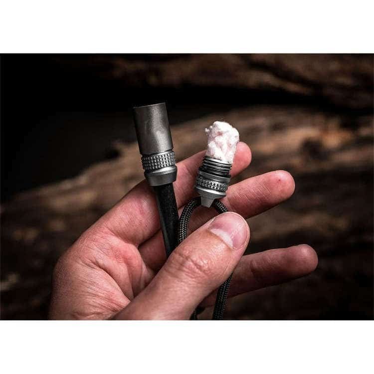Close-up of the ferro rod bulk FRC30 disassembled to reveal the waterproof survival handle with an emergency tinder cotton capsule inside.