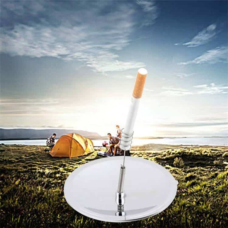 Studio product shot of the emergency solar spark lighter and bulk fire steel replacement tool set against a rugged camping tent background.