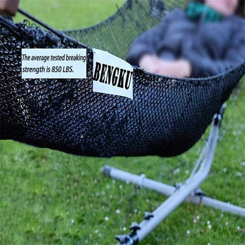 A person resting in a black mesh hammock suspended by a heavy-duty utility cord, with text indicating the average tested breaking strength is 850 LBS.