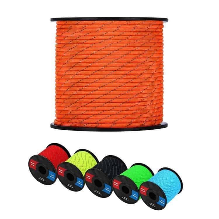 Bulk orange reflective paracord spool with a variety of colorful tactical paracord supplies in red, yellow, black, green, and blue on a white background.
