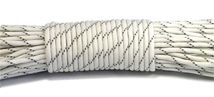 Macro close-up of a single white PRD05 reflective rope showing tight wrapping and highly visible tracer threads, ideal for heavy-duty paracord supplies.