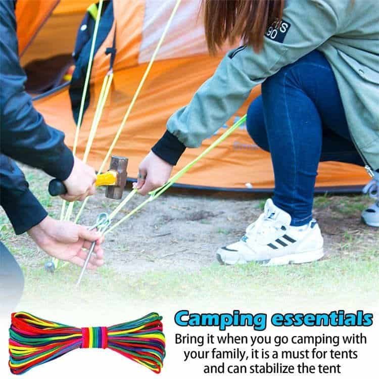 Campers using durable bulk paracord to pitch a tent, demonstrating the reliable outdoor survival utility of ropes from a leading paracord manufacturer.