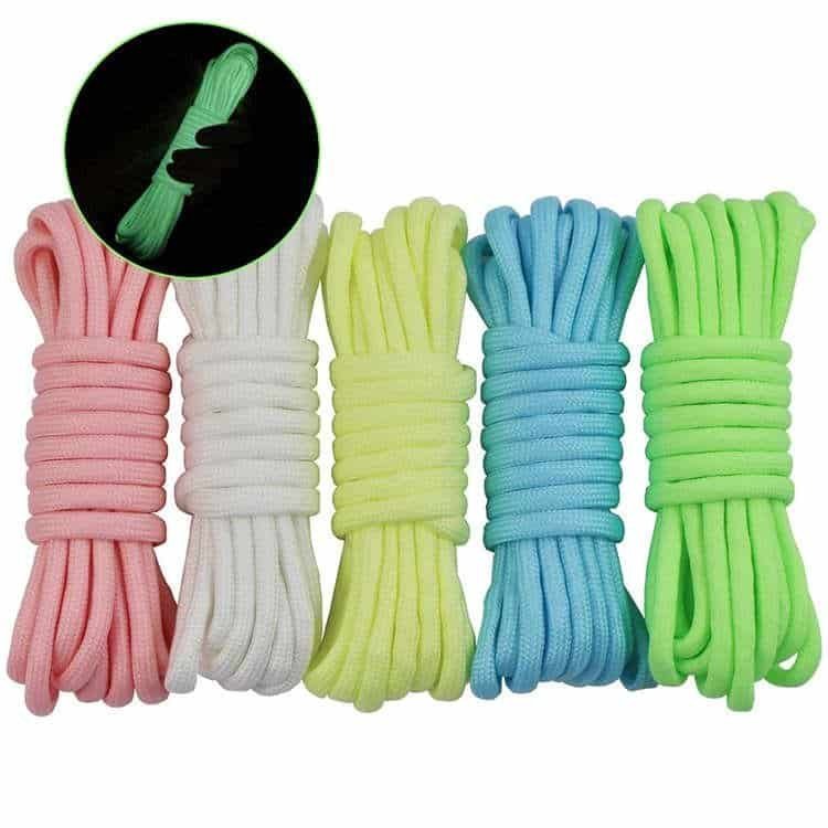 Bright daytime pastel-colored ropes contrasted with a high-visibility glowing bundle in the dark, ideal for bulk paracord wholesale buyers.