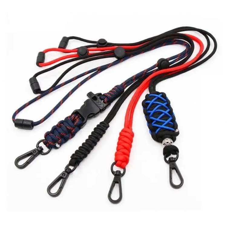 Tactical PL06 wholesale paracord lanyard collection showing diverse weaving styles, zinc alloy clips, and survival whistle buckles.