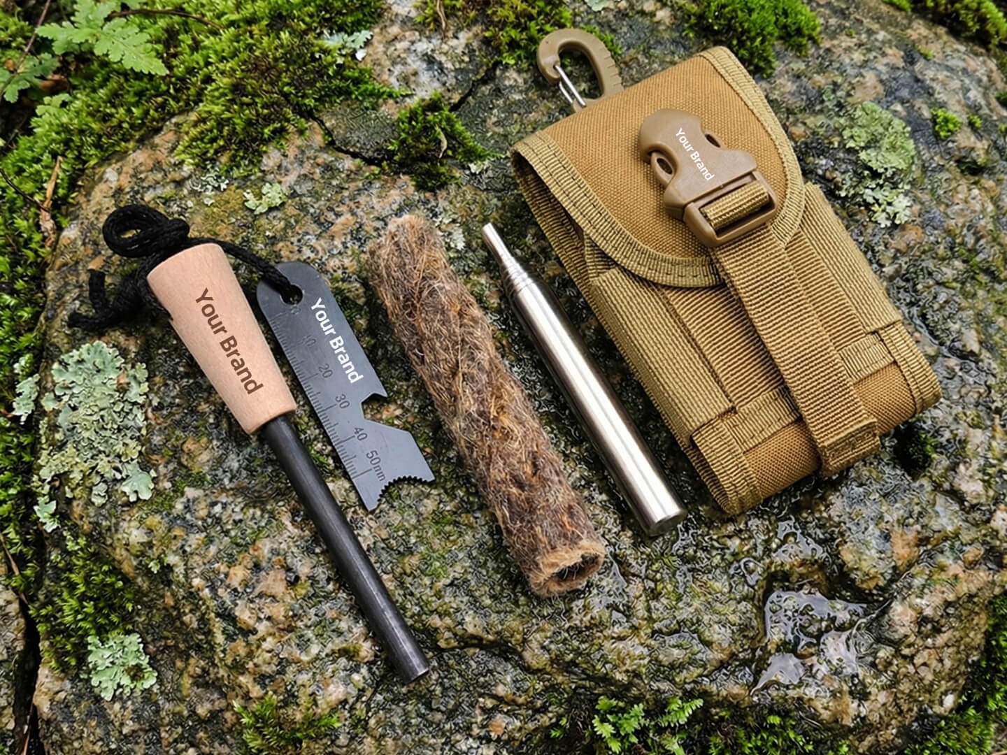 Branded fire starter kit with custom logo engraving, jute cord, and MOLLE pouch on rock