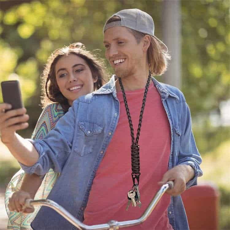 Young man wearing PL03 braided paracord lanyard with HK clip for daily key storage during outdoor bike riding